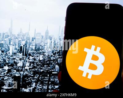 New York, New York, USA. 1st July, 2024. Bitcoin, introduced in 2009 by an anonymous entity known as Satoshi Nakamoto, is the first and most well-known cryptocurrency. It operates on a decentralized ledger called blockchain, which ensures transparent and secure transactions. Bitcoin is often referred to as digital gold due to its finite supply of 21 million coins. It has become a popular investment and a hedge against traditional financial systems, influencing the development of countless other cryptocurrencies. (Credit Image: © Taidgh Barron/ZUMA Press Wire) EDITORIAL USAGE Stock Photo
