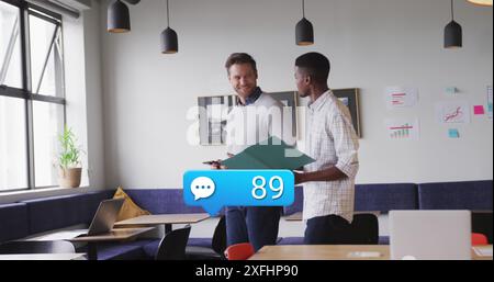 Image of numbers in notification bars, speech bubbles, diverse coworkers discussing reports Stock Photo