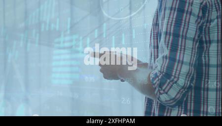 Image of multiple graphs, trading board, loading circles, caucasian man using cellphone Stock Photo