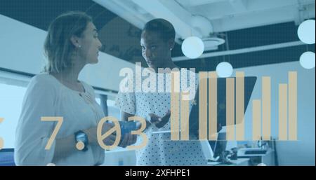 Image of statistical data processing against two diverse women discussing over laptop at office Stock Photo