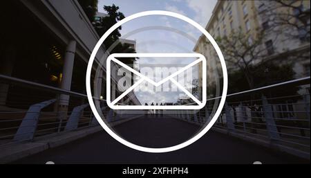 Image of envelope icon over people walking on street Stock Photo