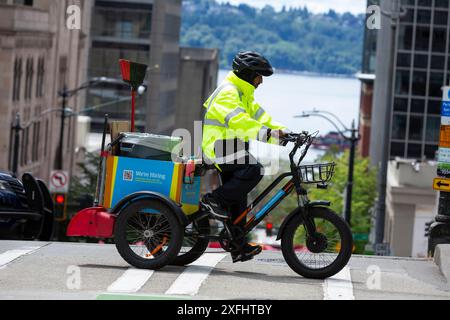 A Community Safety & Hospitality ambassador crosses Columbia Street during the Seattle Pride Parade in downtown Seattle on Sunday, June 30, 2024. Stock Photo