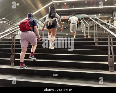 Commuters exiting Fulton Street Subway Station near The World Trade Center Memorial in NYC. The commuter hub was damaged during the Sept.11, 2001 attacks and has since had a 21st Century renovation. Stock Photo