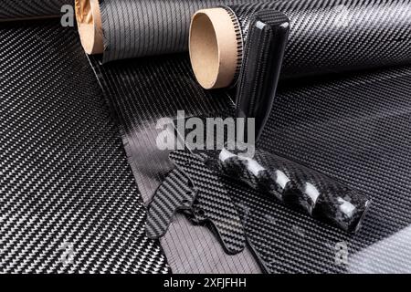 lightweight carbon fiber tuning parts and CFK sheet on composite  raw material cloth.  automotive and car racing  industry and high tech background. Stock Photo