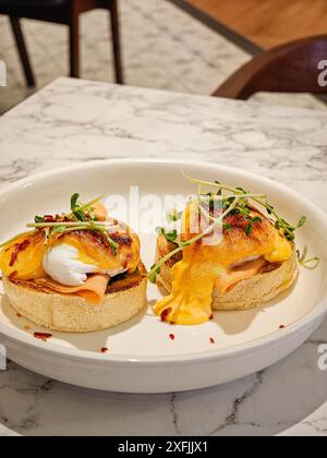 Eggs Benedict on white plate. Delicious breakfast set. Stock Photo