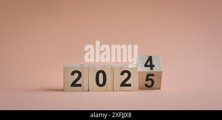 From 2024 to 2025, numbers on wood blocks. New year concept. Stock Photo