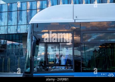 Madrid, Spain. 7 May 2024 Modern electrical low-floor blue bus on a city rout. EMT bus driver on Spanish capital. Municipal vehicle. Urban lifestyle.  Stock Photo