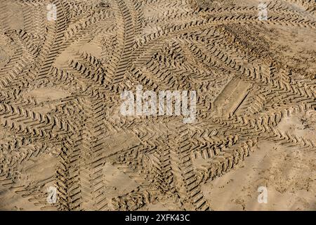 Tyre tire marks in the sand on a beach in Newquay in Cornwall in the UK. Stock Photo