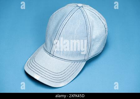 Blue denim cap close-up on blue background Stock Photo