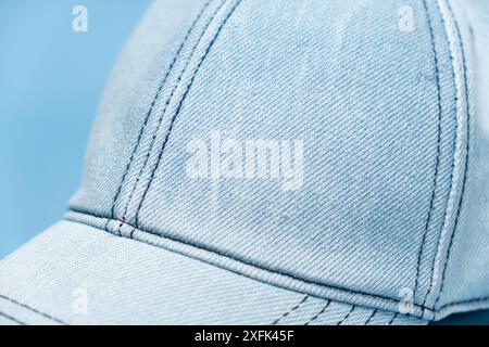 Blue denim cap close-up on blue background Stock Photo