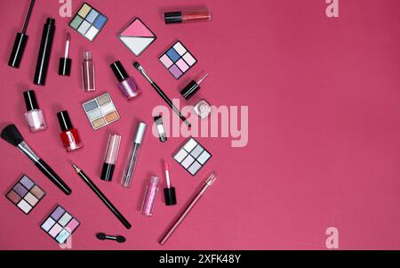 Various decorative cosmetics and brushes on a pink background, copy space for text. Stock Photo