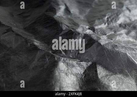 Abstract background of crumpled plastic film. Black and white. Tyvek. Stock Photo