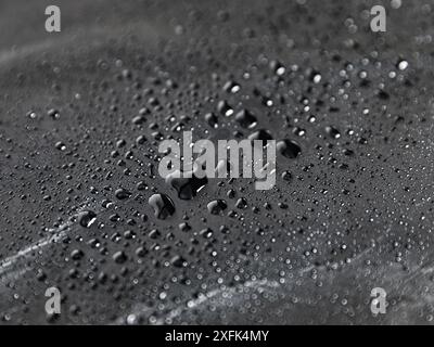 Water drops on paper Tyvek. waterproof material.Black Laminating Technology.Durable material. Stock Photo