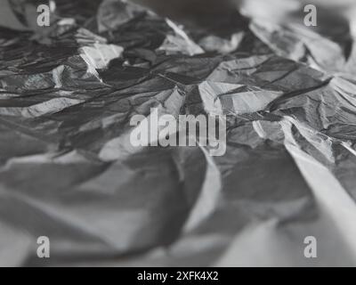 Abstract background of crumpled plastic film. White wrapping paper of Tyvek. Grey. Stock Photo