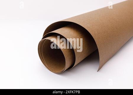 close up of rolled up brown Washable kraft paper on white background with copy space Stock Photo