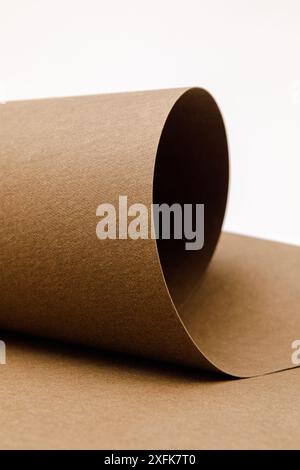 close up of rolled up brown Washable kraft paper on white background with copy space Stock Photo