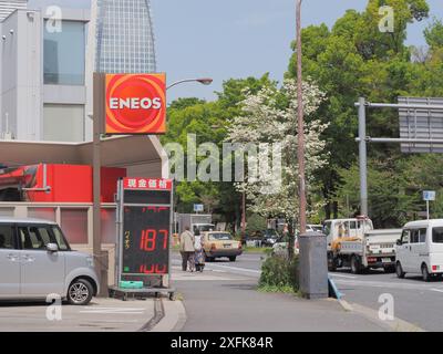 TOKYO, JAPAN - April 16, 2024: An Eneos gas station in Tokyo's Minato Ward. Toranomon Hills Mori Tower is in the background. Stock Photo