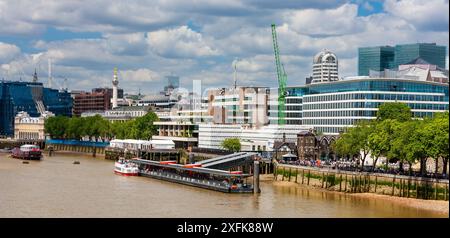 London, United Kingdom - July 5, 2010 : The River Thames north bank west of Tower Bridge. Tower Millennium Pier with building works around the city. Stock Photo