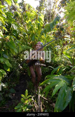 Mentawai hunter with bow and arrow, Siberut, Sumatra, July 2015 Stock Photo