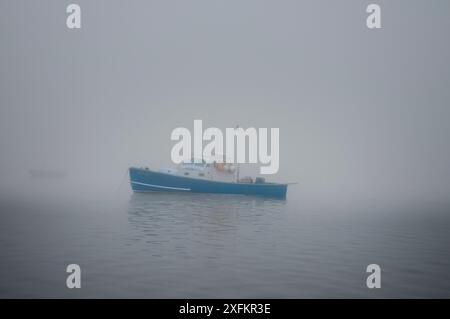 Lobster boat sits in morning fog at harbour, Yarmouth, Maine, USA October Stock Photo