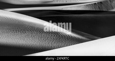 Mesquite Dunes with sand patterned ridges against the Amargosa Mountains  in afternoon light. Death Valley National Park, California, USA, January. Stock Photo