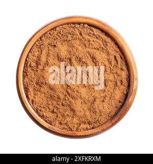 Cassia cinnamon powder in a wooden bowl. Ground raw bark of Chinese cinnamon, also known as Chinese cassia, Cinnamomum cassia. Stock Photo