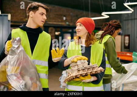 eco-conscious people, in gloves and safety vests, stand together, sorting trash as young volunteers. Stock Photo