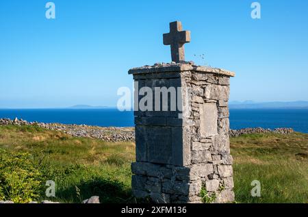 Traditional burial cross, situated along the roadside in Inishmore Island, Aran Islands, Galway County, West Ireland coast Stock Photo