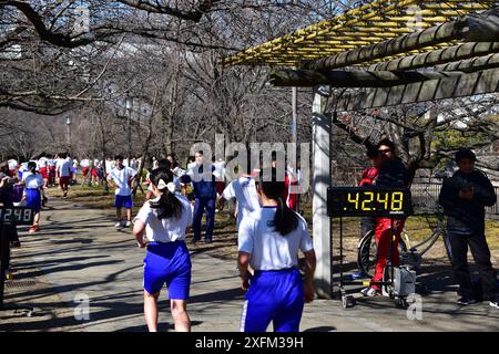 Japanese high school students in gym outfit jogging in Osaka Castle Park during a school running event Stock Photo