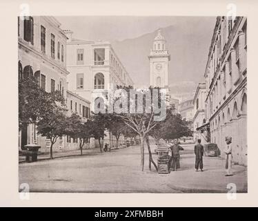 Vintage photo of the Clock-tower, Hong Kong. Illustration of China, 1875 The clock-tower, designed by Mr. Rawling in 1861, is a great ornament to the city. The tower is seen to advantage from the harbour, and the lighted dial of the clock forms a good landmark to guide the benighted steerman to the landing steps at Peddrs Wharf. Stock Photo