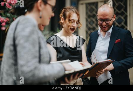 Professionals collaborating and discussing business documents in an outdoor setting Stock Photo