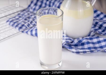 Non-Homogenized, whole milk, cream-top layered dairy product, Creamline Milk concept. Organic farm natural, unpasteurized milk in glass and jug, on wh Stock Photo