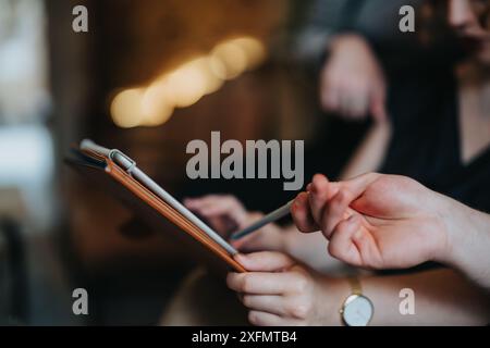 Business meeting with team discussing strategy using a digital tablet in a modern indoor setting Stock Photo