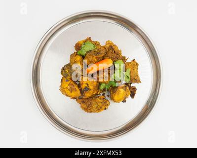 A Plate of Curry Chicken, Fried Spicy Nepali Style Chicken Indian Chicken Dish served on a plate Stock Photo