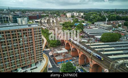 Stockport viaduct with a Northern local commuter train passing over on the approach to Stockport Station Stock Photo