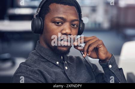 Headphones, serious and portrait of black man in office listening to online podcast for self development. Company, startup and African male web Stock Photo