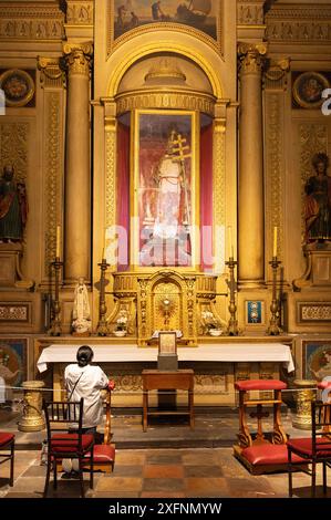 Woman praying at the altar of the Chapel of St Peter; Puebla Cathedral church interior, the Main Catholic cathedral in Puebla, Mexico. Stock Photo