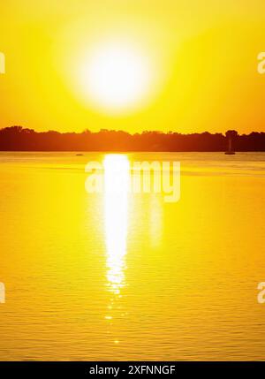Golden Glow Sunrise shimmering over Detroit River south Stock Photo