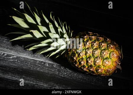 pineapple on black wood background Stock Photo