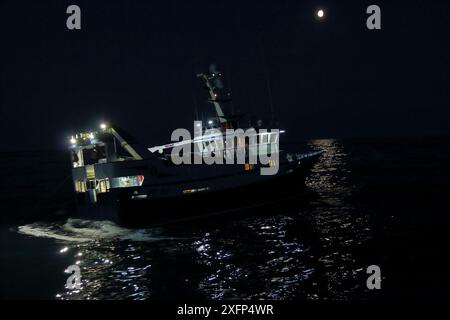 Fishing on a bright moonlit night, North Sea, June 2016.  Property released Stock Photo