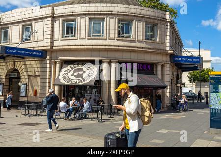 A man checking directions on his phone outside Great Portland Street Station underground tube station London England UK Stock Photo