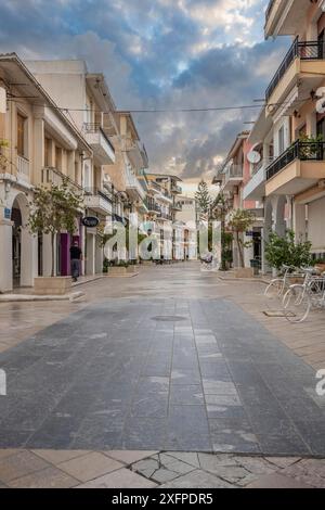 Streets and squares of a town with houses and restaurants in mediterranean flair. Evening at dusk with clouds Zakynthos town, Ionian island Stock Photo