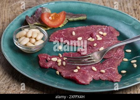 Italian carne salada on a green plate Stock Photo