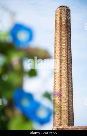 A large old industrial chimney made of red brick Stock Photo