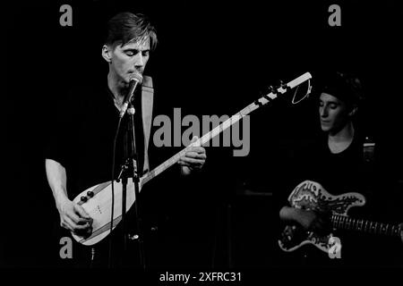 Singer, songwriter and multi-instrumentalist John Rees Lewis, at The Limit in Sheffield, England, in the late 1980s, with the C Cat Trance. Lewis co-founded UK post-punk band Medium Medium, best known for their 1981 single 'Hungry, So Angry.' He went on to co-found C Cat Trance with Nigel Stone, the founding drummer with Medium Medium. C Cat Trance, which had a fluid lineup in the studio and on the road, combined post-punk with elements of Turkish, Middle Eastern and North African music and funk. Both bands were originally formed in Nottingham, England. Lewis passed away in early July 2024. Stock Photo