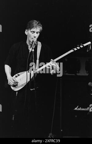 Singer, songwriter and multi-instrumentalist John Rees Lewis, at The Limit in Sheffield, England, in the late 1980s, with the C Cat Trance. Lewis co-founded UK post-punk band Medium Medium, best known for their 1981 single 'Hungry, So Angry.' He went on to co-found C Cat Trance with Nigel Stone, the founding drummer with Medium Medium. C Cat Trance, which had a fluid lineup in the studio and on the road, combined post-punk with elements of Turkish, Middle Eastern and North African music and funk. Both bands were originally formed in Nottingham, England. Lewis passed away in early July 2024. Stock Photo