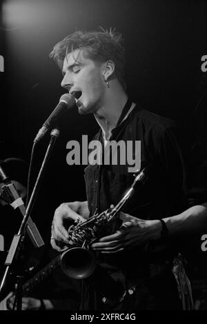 Singer, songwriter and multi-instrumentalist John Rees Lewis, at The Limit in Sheffield, England, in the late 1980s, with the C Cat Trance. Lewis co-founded UK post-punk band Medium Medium, best known for their 1981 single 'Hungry, So Angry.' He went on to co-found C Cat Trance with Nigel Stone, the founding drummer with Medium Medium. C Cat Trance, which had a fluid lineup in the studio and on the road, combined post-punk with elements of Turkish, Middle Eastern and North African music and funk. Both bands were originally formed in Nottingham, England. Lewis passed away in early July 2024. Stock Photo