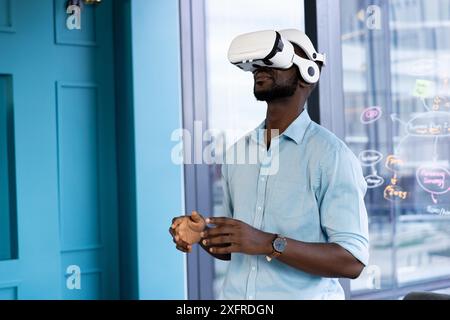 Using VR headset, man exploring virtual reality experience in modern office Stock Photo