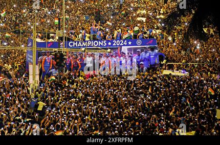 Players of Indian cricket team are seen on an open deck bus as they pass through sea of fans gathered at Marine Drive promenade to celebrate victory . The Indian cricket team beat South Africa in a thrilling twenty twenty (T20) World Cup finals played between them on 29th June 2024 in Barbados. Credit: SOPA Images Limited/Alamy Live News Stock Photo