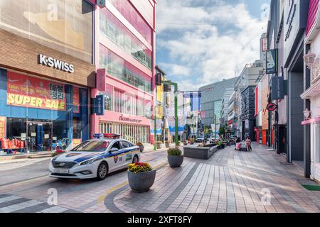 Busan, South Korea - October 7, 2017: Gwangbokro Cultural and Fashion Street in morning. Police car driving down the street. Stock Photo